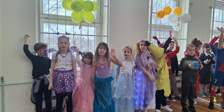 Powiększ grafikę: Uczniowie w przebraniach karnawałowych i nauczyciele podczas balu w sali gimnastycznej.