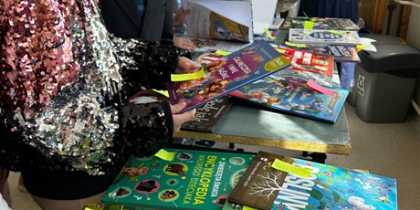 Powiększ grafikę: Uczniowie oglądają książki na kiermaszu na korytarzu szkolnym.