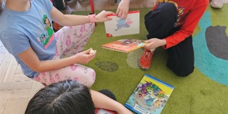 Powiększ grafikę: Uczniowie wymieniają się książkami w sali lekcyjnej.