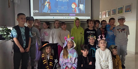 Powiększ grafikę: Zbiorowe zdjęcie uczniów przebranych  za postacie z bajek na korytarzu szkolnym.