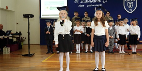 Powiększ grafikę: Uczniowie w sali gimnastycznej podczas pasowania na ucznia.