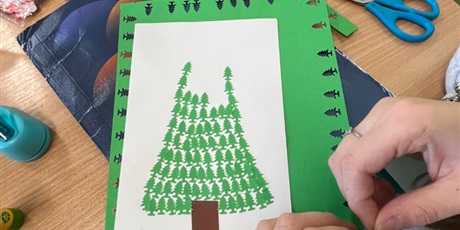 Powiększ grafikę: Uczniowie w sali lekcyjnej wykonują kartki świąteczne.