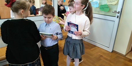 Powiększ grafikę: Uczniowie wypożyczający książki w bibliotece.